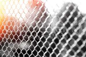 Horizontal prison fence with light leak bokeh background