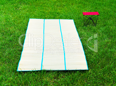 Horizontal vivid bamboo floor mat with chair picnic background