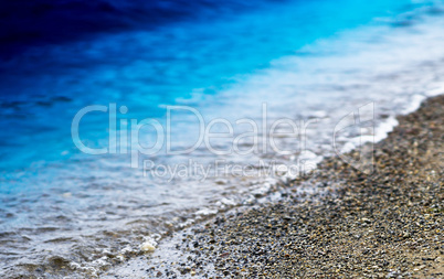 Horizontal vibrant beach pebble bokeh background