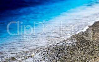 Horizontal vibrant beach pebble bokeh background