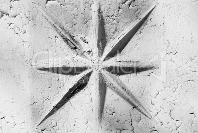 Horizontal black and white star on cracked wall background