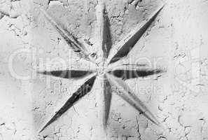 Horizontal black and white star on cracked wall background