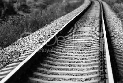 Diagonal black and white railroad track bokeh background
