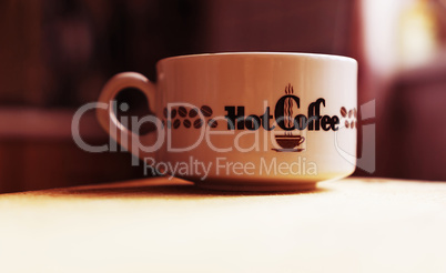 Horizontal hot cup of coffee bokeh background