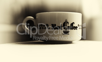 Horizontal vintage hot cup of coffee bokeh vignette background