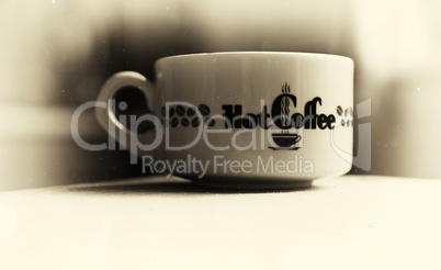 Horizontal vintage hot cup of coffee bokeh vignette background w