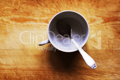 Horizontal empty cup with spoon bokeh background