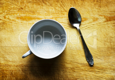 Horizontal empty cup with spoon bokeh background