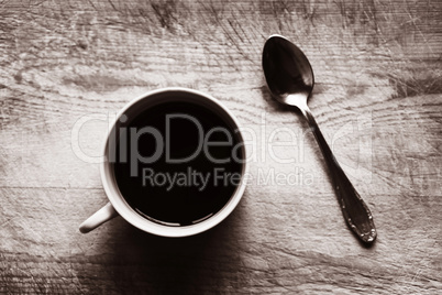 Horizontal cup with spoon bokeh sepia background