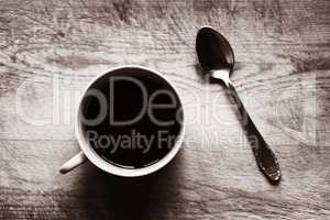 Horizontal cup with spoon bokeh sepia background