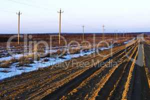 Russian countryside offroad with power lines background