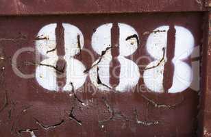 Horizontal vintage cyberpunk number 888 on rusty container backd