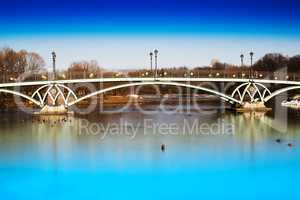 Horizontal dramatic arc bridge in Moscow park background
