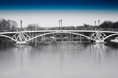 Black and white dramatic arc bridge in Moscow park with blue sky