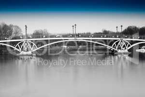 Black and white dramatic arc bridge in Moscow park with blue sky