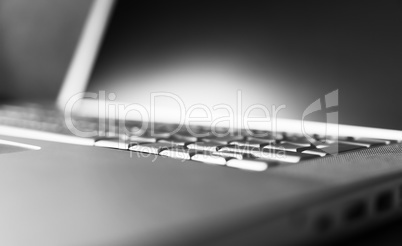 Horizontal black and white laptop keyboard bokeh background