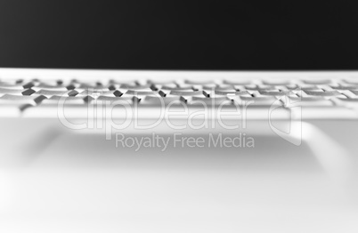 Horizontal black and white laptop keyboard bokeh background