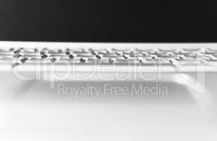 Horizontal black and white laptop keyboard bokeh background