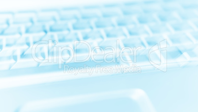 Diagonal cyan laptop keyboard bokeh background