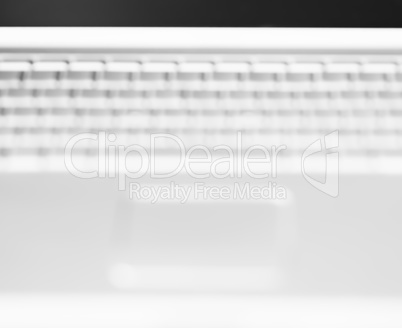 Horizontal black and white  laptop keyboard bokeh background