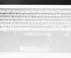 Horizontal black and white  laptop keyboard bokeh background