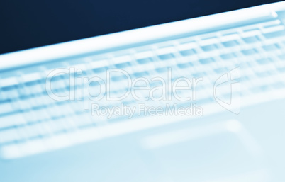 Diagonal cyan  laptop keyboard bokeh background