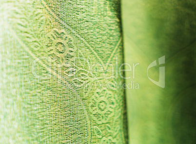 Vertical vivid green fabric bokeh background