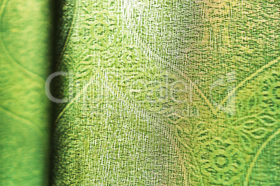 Horizontal vivid green fabric bokeh background