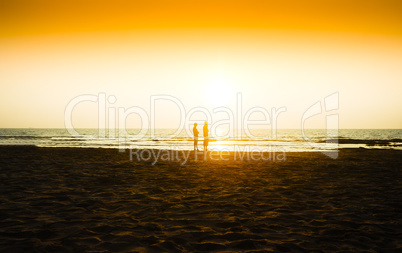 Two friends meeting sunset on ocean beach background
