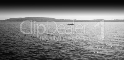 Horizontal black and white boat in ocean horizon landscape backg