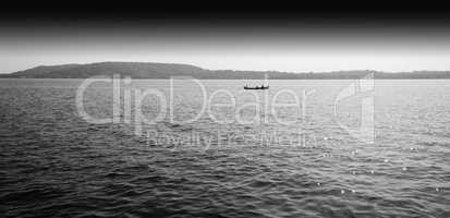 Horizontal black and white boat in ocean horizon landscape backg