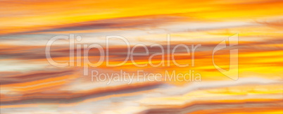 Horizontal vibrant orange sunset cloudscape background backdrop