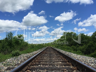 Railway to horizon and clouds on the sky background.