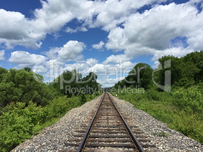Railway to horizon and clouds on the sky background.