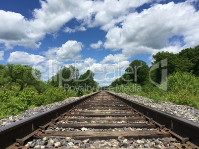 Railway to horizon and clouds on the sky background.