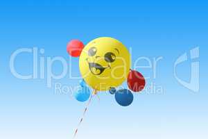 Yellow balloon flying on a blue sky background