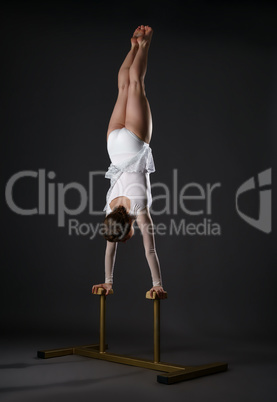 Gymnastics. Shot of flexible woman doing handstand