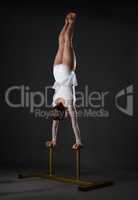 Gymnastics. Shot of flexible woman doing handstand