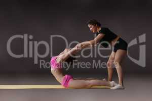 Photo of woman helping her friend do stretching
