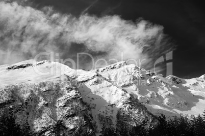 Black and white view on off-piste ski slope at sun windy day