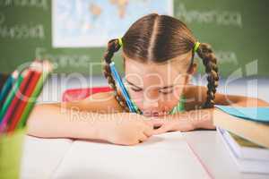 Schoolgirl doing homework in classroom