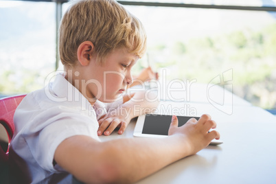 Schoolkid using digital tablet in classroom