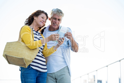 Couple holding map in city