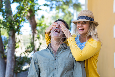 Woman covering boyfriend eyes