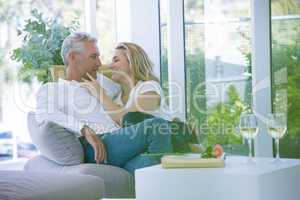 Romantic mature couple sitting on armchair