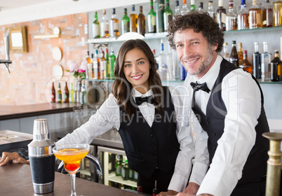 Portrait of waiter and waitress smiling Portrait of waiter and waitress smiling