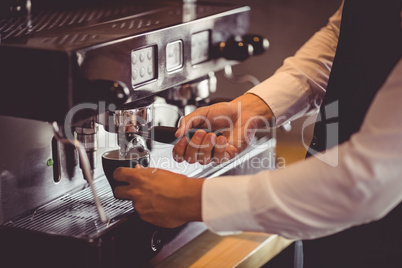 Waiter using coffee machine