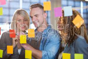 Businessman explaining to colleagues over sticky notes