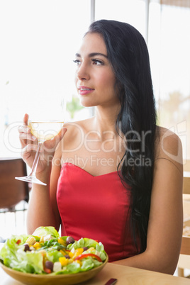 Beautiful woman having champagne with food salad