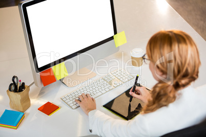 Creative businesswoman working at computer desk